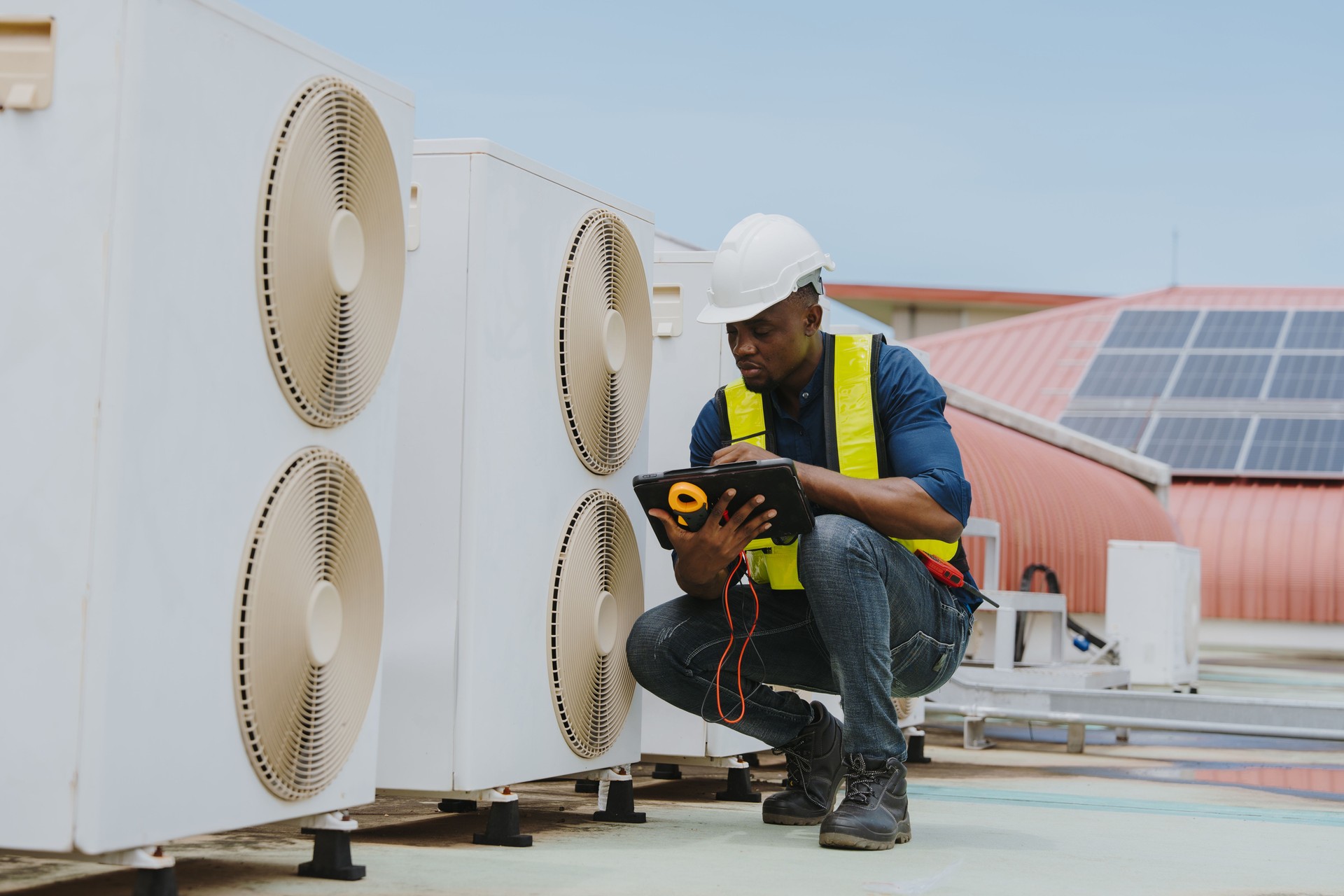 Engineers are checking the air conditioning and cooling system in a commercial building.