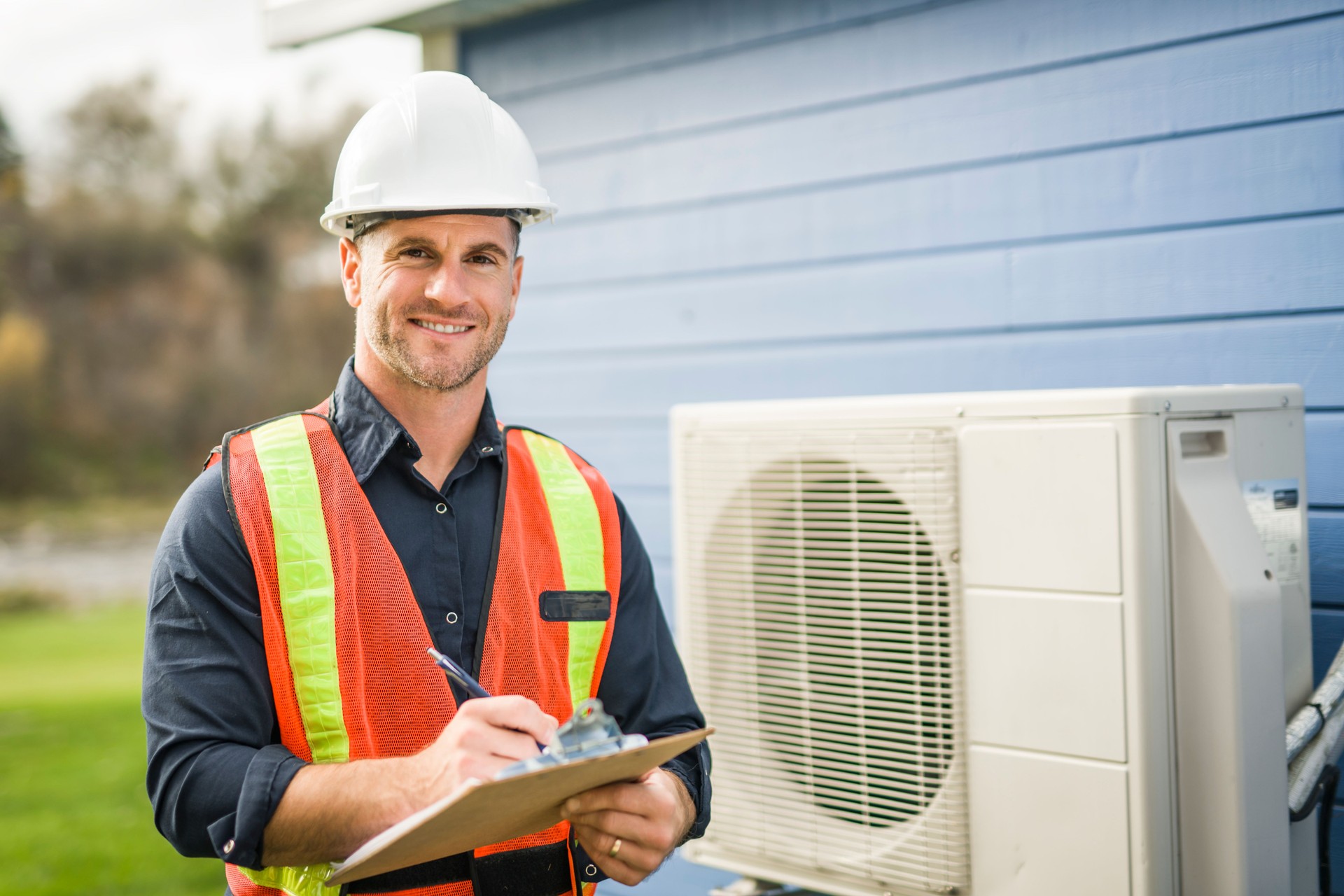 technician working on air conditioning or heat pump outdoor unit